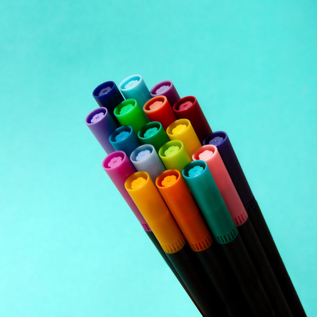 OMY colorful markers on a turquoise background
