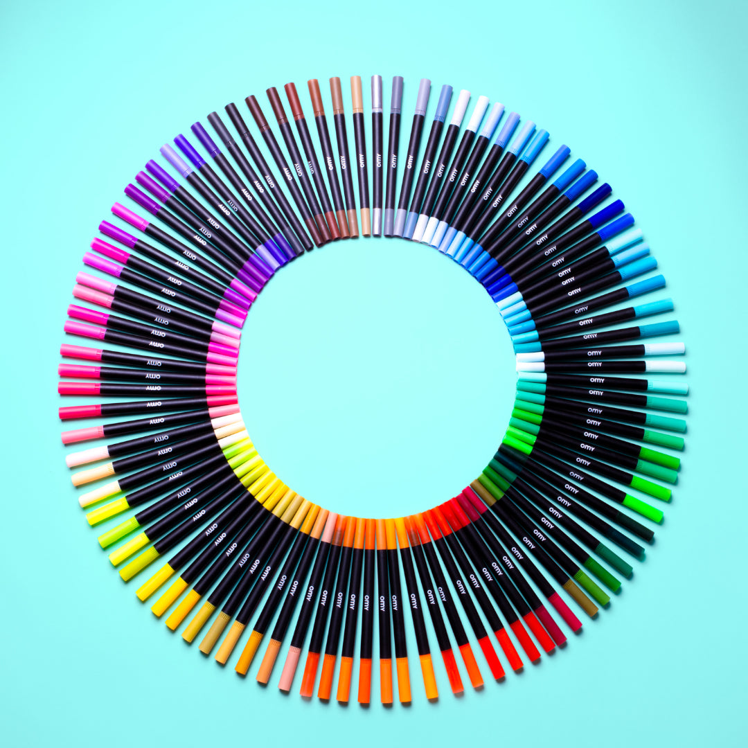 Set of OMY colorful markers arranged in a circular pattern on a light blue background