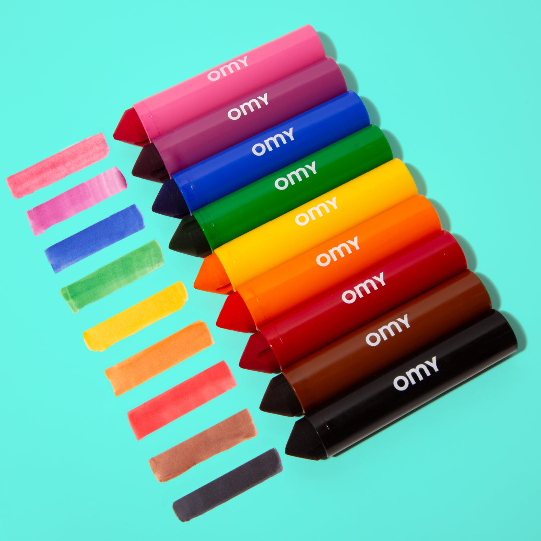 Set of OMY colorful crayons on a turquoise background
