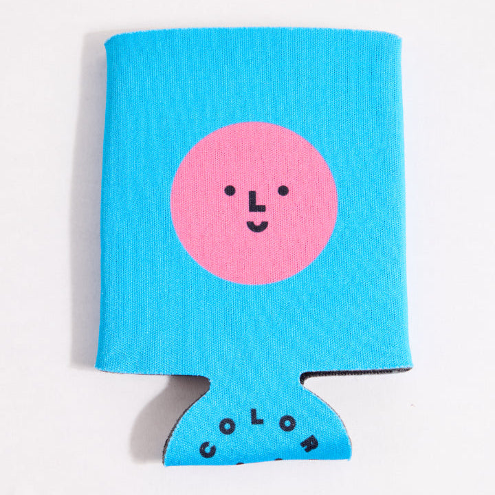 Blue can cooler with a pink circle and smiley face on a white background