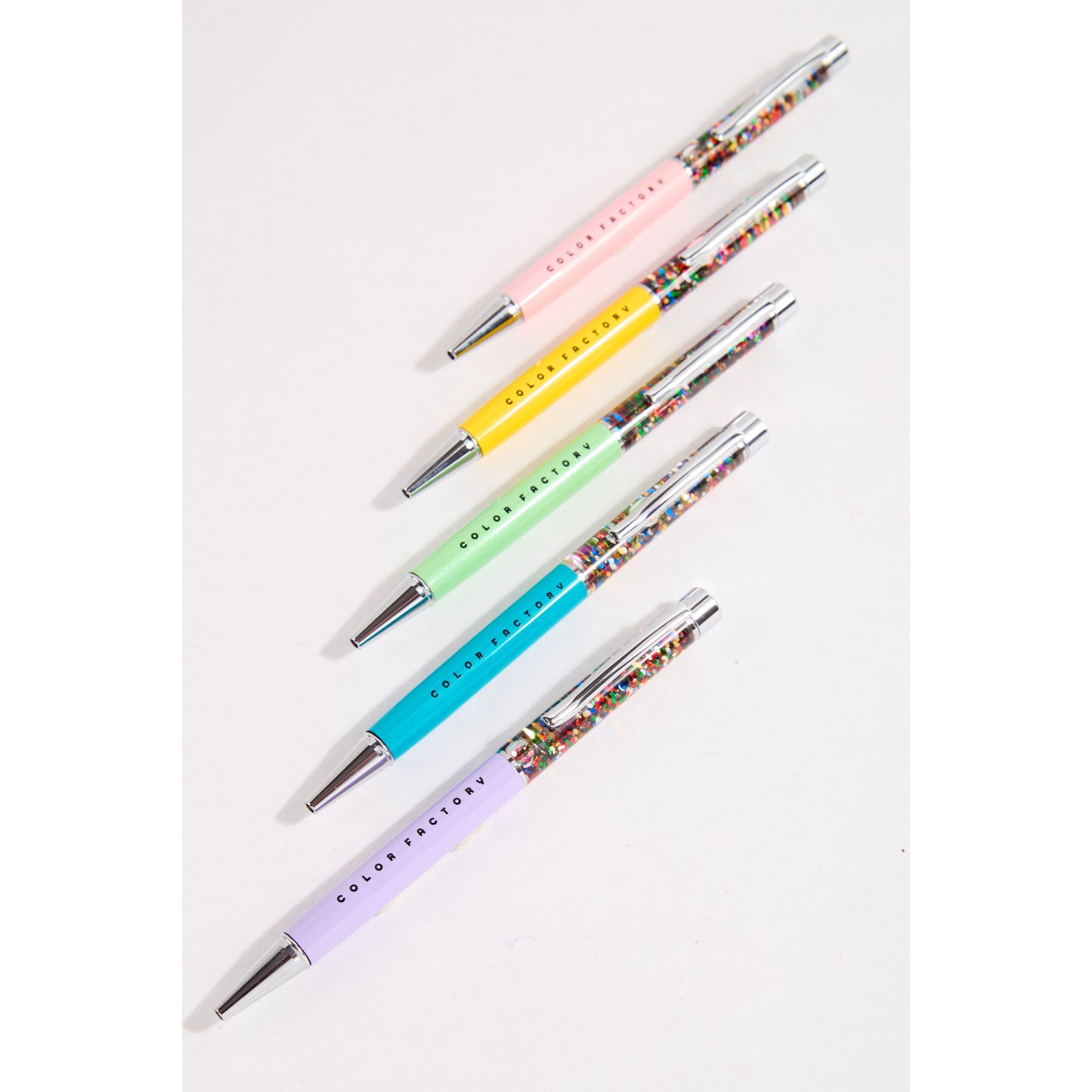 5 colorful pens laid flat on a white background