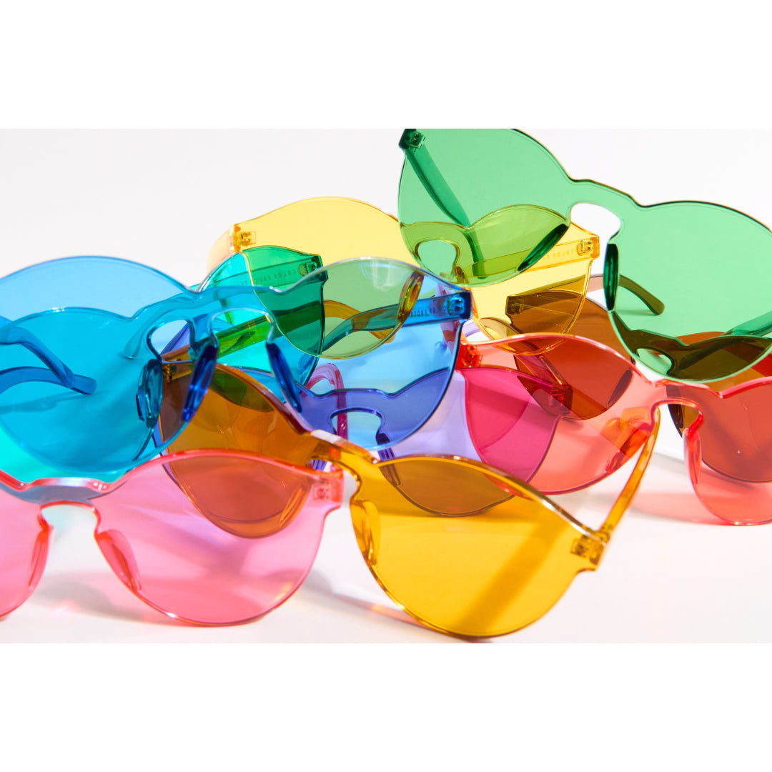 Colorful sunglasses with blue, green, yellow, orange, and pink lenses on a white background.