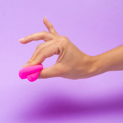 Hand holding pink 'do' against a purple background
