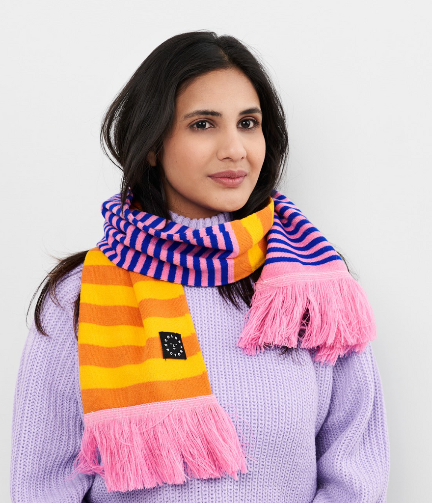 Striped, knitted scarf in bright colors. Features yellow, orange, pink and cobalt colors. 